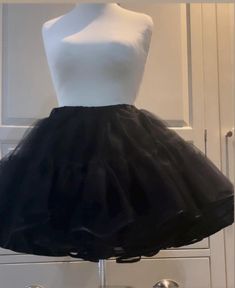 Handmade, made to order, black dress net vintage style,circle skirt style.Available in UK clothing size. Small 10-12, medium 12-14, large 16-18, and X-Large size 20-22.The length is above- the-knee. The waistband has an elastic inside. washable with matching delicate colours. The length is 40cm(16")with 3 layers of dress net,each consisting of 2 tiers,and a soft polyester material underskirt. Edged in a delicate black bias trim.Ideal for the festive season too! Ideal present for your wife, girlf Party Skirt With Can-can Crinoline, Black Dress With Tulle Full Skirt, Black Full Skirt Petticoat For Party, Black Tulle Full Skirt, Black Full Dress With Ruffled Skirt, Black Full Tulle Skirt, Black Tiered Skirt Petticoat For Party, Black Ruffled Skirt For Wedding, Black Ruffled Tulle Petticoat