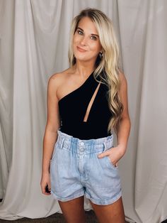 Bottoms feature a true denim material Style Shorts, Denim Material, Suede Material, Bag Style, Explore The World, Piece Of Clothing, Solid Black, One Shoulder Blouse, Strapless Top