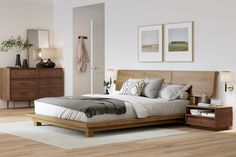 a bedroom with white walls and wooden furniture