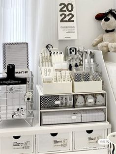 a white desk with drawers and a stuffed animal