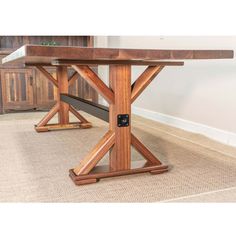 a wooden table sitting on top of a carpeted floor