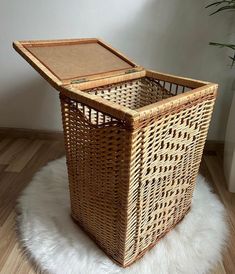 a wicker basket sitting on top of a white rug