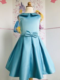 This beautiful interview dress with bow can be made special for your little girl in any size and color. Ready to ship in 3-4 weeks. Formal A-line Dress With Satin Bow, Elegant Blue Princess Dress With Bow, Elegant A-line Pageant Dress, Elegant Dresses With Pleated Bodice For Dress-up, Elegant Dresses With Pleated Bodice For Formal Occasions, Blue Princess Dress For Formal Occasions, Light Blue Elegant Dress For Dress-up, Elegant Light Blue Dress For Dress-up Occasions, Elegant Light Blue Dress For Dress-up