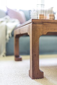 a close up of a coffee table with a couch in the background