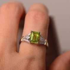 This ring features a 6mm*8mm natural peridot and sterling silver finished with gold and rhodium. Customization is available. It is made by hand, and it will take about 7 days to finish the ring after your payment is completed. Any question, just let me know. :) My shop homepage: https://www.etsy.com/shop/LuoJewelry?ref=l2-shopheader-name Etsy Wedding Rings, Peridot Ring, Yellow Gold Rings, Emerald Cut, Promise Rings, Wedding Ring, Heart Ring, Emerald, Wedding Rings