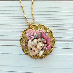 Thoughtfully curated mosaic of vintage pieces creating a stunning and eye-catching handmade pendant in a soft blush color palette hung on 33-inch gold plated chain. Gorgeous vintage vibe! Only one of its kind! Makes a great gift or treat yourself! Thanks for looking! Artisan Gold Jewelry With Vintage Charm, Pink Necklace With Large Pendant, Unique Pink Necklace With Large Pendant, Pink Vintage Charm Pendant Jewelry, Unique Pink Vintage Charm Jewelry, Gold Bohemian Charm Necklaces, Unique Pink Jewelry With Vintage Charm, Personalized Vintage Pink Jewelry, Whimsical Gold Jewelry With Vintage Charm