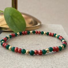 Christmas Seed Bead Bracelets This design bracelets are made of green agate, pearls and red agate stones.  When people think of the colors red and green, one thing comes to mind: Christmas.  Red has long been a powerful color associated with fire, spiritual awakening, and the blood of Jesus Christ, whose birthday is celebrated on December 25.  Green often symbolizes money, good luck, and health through the holidays and into the new year. ☆ Each of the pearls we use to create bracelets were forme Festive Green Beaded Bracelets With Colorful Beads, Festive Green Beaded Bracelets, Festive Colorful Beaded Bracelets, Festive Colorful Beads Bracelet, Festive Christmas Beads With Round Shape, Festive Christmas Beads, Christmas Festive Round Beads, Festive Green Beaded Bangle Bracelets, Green Beaded Bracelets For Festive Occasions