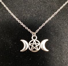 Triple moon goddess charm, alloy coated brass. Charm is about an inch long and not double sided (see pics). Chain is 18 inches and stainless steel. Symbolic Metal Necklace With Moon Phase Detail, Silver Moon Phase Charm Necklace, Symbolic Moon-shaped Metal Necklace, Silver Metal Moon Phase Charm Necklace, Symbolic Moon Shaped Metal Necklace, Symbolic Crescent Nickel-free Necklace, Symbolic Crescent Nickel Free Necklace, Silver Metal Moon Charm Necklaces, Silver Metal Moon Shape Charm Necklaces