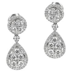 A pair of Round Diamond in Circular and Pear Shape Dangling Earrings made in 14 Karat White Gold. The total weight of the earrings is 4.19 grams. The appx. weight of the diamonds is 1.75 carats. Pear-shaped Diamond Earrings With 17 Jewels, Formal Pear-shaped Brilliant Cut Earrings, Hallmarked Pear-shaped White Gold Diamond Earrings, Luxury Hallmarked Pear-shaped Diamond Earrings, Pear-shaped Hallmarked White Gold Diamond Earrings, Formal Pear-shaped Brilliant Cut Cluster Earrings, Timeless Diamond Cut Pear-shaped Earrings, Classic Hallmarked Pear-shaped Diamond Earrings, Timeless Pear-shaped Brilliant Cut Earrings