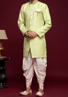 Ready-Made Sherwani With Peshawari Trouser. All Over Jacquard Brocade Style Fabric Top. Art Silk Peshawari Ready Made Trouser. Crafted in Chinese Collar Neck, and Full Sleeve. Satin Lining with Plain Work. High-Quality Matching Buttons. Please Note: The footwear shown in the picture is for presentation and photography purpose only. Color: There might be slight color variation due to lightings and flashes while photo shooting. The color may also vary because of different screen resolutions. Wash Designer Pista Green Kurta For Navratri, Green Kurta With Naqshi And Traditional Drape, Green Kurta With Naqshi In Traditional Drape, Bollywood Art Silk Sherwani With Chikankari Embroidery, Festive Designer Sherwani With Chikankari Embroidery, Pista Green Kurta With Resham Embroidery, Art Silk Bandhgala With Chikankari Embroidery For Festive Occasion, Festive Art Silk Bandhgala With Chikankari Embroidery, Pista Green Raw Silk Churidar With Traditional Drape