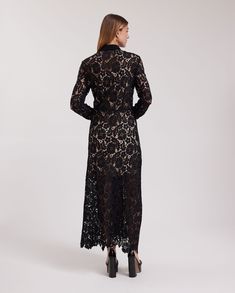 The VIOLETA is a semi-sheer black floral lace dress with a pointed collar and a white button placket that extends down the center front. This full-length dress features a removable sheer dress lining and long sleeves that are finished with single cuffs that allow for cufflinks. The VIOLETA is adorned with a delicate floral scalloped hem and princess darts on the back for a more accentuated silhouette. The VIOLETA dress is being revisited for the Spring-Summer 2023 collection as a complimentary s Sheer Long Sleeve Lace Dress For Evening, Elegant Sheer V-neck Lace Dress, Evening Long Lace Maxi Dress, Evening Lace Long Maxi Dress, Elegant Sheer Maxi Length Lace Dress, Elegant Sheer Lace Maxi Dress, Formal Sheer Lace Maxi Dress, Evening Dress With Sheer Sleeves, Elegant Midi Dress With Sheer Sleeves For Dress Down