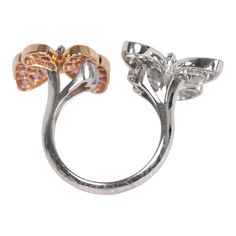 This Van Cleef & Arpels two butterfly "between the finger" ring features 18K rose gold, rhodium plated white gold, and 34 round pink sapphires diamonds of 0.88 carat each, and 36 white gold marquise-cut diamonds that are 0.99 carat each. Origin: FranceCondition: Pre-owned; Excellent - moderate Scratching to back of ringAccompanied by: VCA green jewelry box and authenticity card Measurements: Ring Size: 52 | US Size: 6 Elegant Butterfly Ring With Diamond Accents, Elegant Butterfly-shaped Rings With Diamond Accents, Luxury Butterfly Ring With Diamond Accents For Formal Occasions, Luxury Diamond Butterfly Ring For Formal Occasions, Luxury Formal Butterfly Ring With Diamond Accents, Elegant Round Butterfly Ring For Formal Occasions, Luxury Butterfly Ring For Formal Occasions, Luxury Butterfly Ring For Anniversary, Luxury Butterfly Ring For Wedding