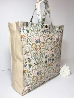 Nikki's Original Totes - The fashionable bag for life! All hand-made to order by myself here in Devon. Liberty in Stone is a very arts and crafts styled fabric reminiscent of William Morris, It is now only available with a plain pale pink gusset which compliments the pink of the flowers. Inside I have used a sage green water resistant fabric which also complements the design.  I only use high quality 100% cotton oilcloth to design & create your individual tote bag. A tote bag by definition is an open topped unlined hand-held bag made from a hard wearing fabric. I have taken the original design & improved on it by adding a hidden zip top and a popper fastener.  I have placed a piece of cut plastic in the base to aid stability and added a water resistant double slip-in pocket. I have also st Safety Pictures, Rose Pale, Green Water, Zip Tote, Oil Cloth, Water Resistant Fabric, William Morris, You Bag, Devon