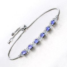 Tanzanite Bracelet, Real Tanzanite Oval Bolo Bracelet in .925 Sterling Silver, December Birthstone, Anniversary Gift, Bridesmaid Gift This 1.98-carat genuine tanzanite bolo bracelet showcases the enchanting allure of tanzanite in a sleek .925 sterling silver setting. The vibrant stones are arranged along a delicate chain, allowing their stunning color to take center stage. The bolo design offers both comfort and style, making this bracelet a versatile accessory that adds a sophisticated touch to Adjustable Oval Fine Jewelry Bracelet, Adjustable Oval Sterling Silver Bracelet For Anniversary, Oval Sapphire Bracelets As Gift, Elegant Adjustable Oval Crystal Bracelet, Tanzanite Bracelet, Bolo Bracelet, Aquamarine Jewelry, Silver Gemstone Jewelry, 18k Gold Jewelry