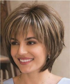 an image of a woman with short hair smiling for the camera, and she is looking at the camera