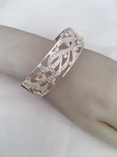 "Amazing Branch Wave Openwork Wide Hinged Bangle Beacelet Front Design Has Cubic Zirconia Stones 925 Sterling Silver Weighs 55 Grams Outside length 2.87\" x 2.38\" Width - 0.87\" New old stock Beautiful new bracelet Visit our shops on Etsy HauteCoutureLaLa TrendsCouture BeautifulPatina LastingTrends Combine shipping within first three shops listedFree Shipping on orders over $35.00 however if there is a return buyer to refund seller for the free shipping cost to seller. BeautifulPatinaFree shipp Elegant Sterling Silver Cuff Bracelet For Party, Silver Diamond Crystal Bracelet, Elegant Sterling Silver Bangle For Party, Elegant Sterling Silver Bangle Crystal Bracelet, Silver Crystal Bracelet With Sparkling Stones, Silver Elegant Cuff Bracelet With Diamond Accents, Silver Cuff Bracelet With Diamond Accents, Silver Diamond Bracelet With Sparkling Stones, Luxury Silver Bangle With Sparkling Stones