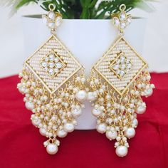 Metal = Gold Plated Occasion = Wedding ,Party Wear, Bridal Color = White and Yellow Size = Earrings Size - 3.5 Inches(approx) Closure = Screw Back Weight = 25 gram each Earring 100% Satisfaction Guarantee: 1 Year Warranty, Long Lasting Plating, High-Quality Stones Occasion: Perfect choice for any Indian occasion. Care: It is advisable that you keep products away from direct heat, humidity, and moisture. It is best to preserve your jewelry in the box. Keep Away From Water, Spray And Perfumes For Elegant Bridal Earrings For Marriage And Festivals, Elegant Bridal Earrings For Weddings And Festivals, Handmade White Chandelier Earrings For Anniversary, Elegant Beaded Earrings For Weddings And Festivals, Traditional White Bridal Earrings As Gift, Elegant Festive Beaded Earrings For Wedding, Elegant Chandbali Earrings For Marriage, Traditional White Beaded Earrings For Celebration, Festive Silver Earrings For Marriage