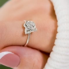 Embrace the beauty of nature with our 3D-printed Rose Ring. This intricately crafted piece captures the essence of a blooming rose, making it a stunning accessory for flower enthusiasts and nature lovers alike. Whether as a gift or a treat for yourself, this delicate and dainty ring is sure to make a lasting impression. Size: Varies by size about 2.5-3.5 tall and 1.2-1.3 thick Elegant Adjustable Rose-colored Ring, Anniversary Flower Ring With Rose Design, Delicate Rose Flower Shaped Jewelry, Elegant Sterling Silver Ring With Rose Design, Elegant Rose Flower Ring In Sterling Silver, Rose Design Open Ring Jewelry Gift, Elegant Rose Sterling Silver Flower Ring, Dainty Rose Design Flower Ring For Gift, Dainty Rose Design Flower Ring For Anniversary