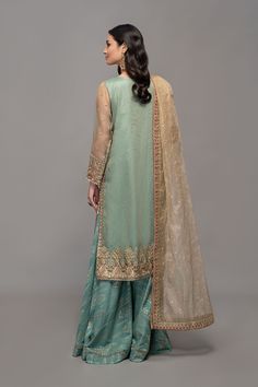 Sharara Style Salwar Kameez Pakistani Eid Dress is an exquisitely designed Zari net fully embroidered shirt with embroidered sleeves Jacquard sharara which can be customized according to your choice. It is paired with a zari net embroidered dupatta. Detailed Description: SKU: PN800 Detailing: Gota, sheesha, dabka, sequins Color: Ferozi Fabric: Raw Silk, Net, Organza Design: Fully embellished, Embroidery, Dabka Event: Eid Party, Wedding, Festive, Party wear Pakistani Party Dresses, Salwar Kameez Pakistani, Eid Dresses, Pakistan Fashion, Maria B, Ready To Wear Collection, How To Dye Fabric, Pakistani Fashion, Raw Silk