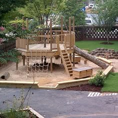 a wooden play set in the middle of a yard