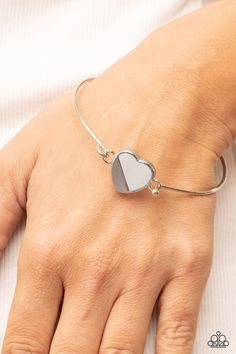 A glistening silver plate slants across a white shell-like heart charm that delicately hinges to a dainty silver bangle-like bracelet, creating a charming centerpiece around the wrist. Features a barbell closure. Sold as one individual bracelet. Squirrel Jewelry, Intention Bracelets, Hook Bracelet, White Bracelet, White Bracelets, Paparazzi Accessories, Gold Bangle, Silver Bangle, Affordable Jewelry