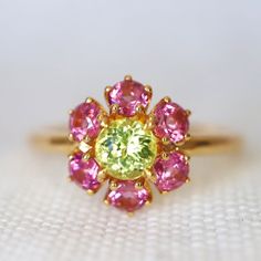 Neon Yellow Mali Garnet Ring. With Pink Malaya Garnets. Yellow and Pink Engagement Ring. Dainty Engagement Ring. 14K Rose Gold. Size 6.75 Condition: Brand New & Custom Designed by me Size: US 6.75 sizable Metal: Solid 14K Yellow Center Stone: Untreated Neon Yellow Mali Garnet 0.45ct Side Stones: Untreated Brilliant Cut Malaya Garnets 0.85ct.  Measurement: 9mm*9mm. Height 4mm. Certificate Included. 7-day return accepted. This item is brand new exclusively designed by me. This item will be sent in Yellow Gold Multi-stone Sapphire Promise Ring, Luxury Yellow Sapphire Multi-stone Ring, Exquisite Pink Sapphire Gemstone Rings, Yellow Gold Rings With Yellow Sapphire And Accent Stones, Yellow Gold Pink Sapphire Rings For Wedding, Wedding Rings In Yellow Gold With Pink Sapphire, Yellow Sapphire Gemstone Rings, Yellow Sapphire Jewelry With Accent Stones In Yellow Gold, Yellow Sapphire Gemstone Promise Ring