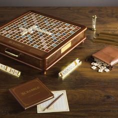 a wooden table topped with an old fashioned game board and pieces of paper next to it