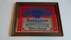 an old budweiser advertisement hangs on the wall