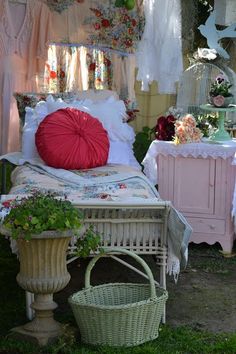 a bed and table in a room with flowers on the walls, plants growing out of it