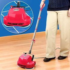 a woman using a red vacuum cleaner on the floor