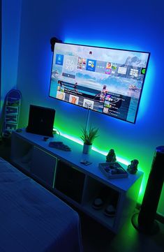 a flat screen tv sitting on top of a white shelf next to a bed in a room