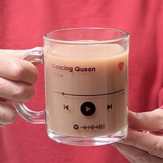 a person holding a coffee mug with the words dancing queen on it