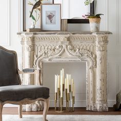 an ornate fireplace with candles in front of it