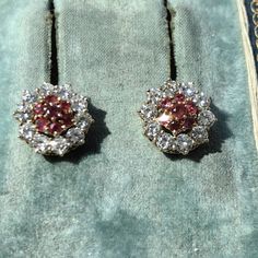 Earrings Size: 11.2 mm Metal Type: 18k gold  Weight: 4.15 grams Diamonds: 1.40 ct. Rubies:0.50 ct. Color: G Clarity: VSI-Si Natural ruby: 0.50 ct. Condition: Excellent Ruby and diamond 18k gold earrings. Featuring natural altogether 0.50 ct. rubies with a raspberry red color, and very bright and clear altogether 1.40 ct. diamonds with G color and VSI-Si clarity. The diamond frame around the rubies is removable so you can wear the earrings with or without it. The earrings weigh 4.15 grams and are White Gold Earrings With Jewels, Pink Brilliant Cut Round Diamond Earrings, Cluster Halo Design Earrings As Gift, Cluster Halo Design Earrings For Gift, Classic Pink Hallmarked Earrings, Pink Round Diamond Earrings For Wedding, Pink Round Fine Jewelry Earrings, Pink Round Cut Earrings For Formal Occasions, Hallmarked Round Cluster Earrings For Anniversary