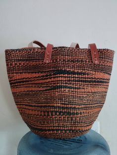 "Black and orange sisal tote bag DIMENSIONS Bottom width: 10\"/25.5cm Top width: 14\"/35.56cm Depth: 10\"/25.5cm Straps: 15\"/38cm SHIPPING All orders ship via DHL Express (3-5) days delivery time." Woven Handbags, Maasai, Handmade Bag, Black And Orange, Handmade Bags, Dhl Express, Hobo Bag, Kenya, Straw Bag