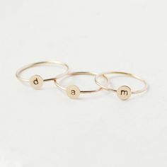 One gold letter ring. Personalize a gift she'll treasure with our gold initial ring. An adorably petite initial, imprinted on a 14k gold filled disk - paired with a super skinny (1mm) gold filled band - creates the perfect stacking ring, customized with your monogram. Lovely as a stand alone. Also sits beautifully with multiple initials stacked or our hammered gold stacking ring bands. This gold initial ring arrives custom made to order in your size hand stamped with the letter of your choice. A Initial Ring Gold, Gold Initial Ring, Rose Gold Initial, Gold Stacking Ring, Ring Bands, Letter Ring, Stacking Ring Set, Gold Letter, Gold Monogram