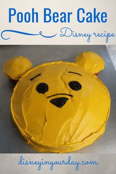 a winnie the pooh cake with yellow frosting on top and blue lettering that reads, pooh bear cake disney recipe