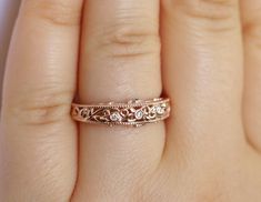 This is a truly stunning wedding ring with breathtaking delicate pattern details. This beauty has a rustic inspiration of leaf filigree mixed with vintage Edwardian feminine style. Absolutely breathtaking and ideal for everyday wear. You are going to fall in love with it from the minute you put this marvelous art on your finger. 14k Rose Solid Gold 3 Natural Diamonds G-H Color/ VS Clarity Weight: .04 approximately 2 Natural Emeralds Weight: .02 carat approximately Proudly made in USA. Ethical So Elegant Filigree Ring With Intricate Design For Marriage, Dainty Round Cut Wedding Ring, Wedding Diamond Jewelry With Intricate Design, Elegant Wedding Ring With Rose Cut Diamonds, Elegant Rose Cut Diamond Wedding Ring, Elegant Wedding Single Cut Diamonds Jewelry, Elegant Filigree Ring With Single Cut Diamonds For Wedding, Vintage Filigree Ring With Decorative Band For Wedding, Exquisite Wedding Rings With Single Cut Diamonds