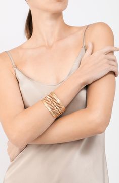 Get a trendy stacked look with this gleaming cuff bracelet finished in shiny 14-karat gold plate. 1 1/2" width 14k-gold plate Imported Chic Gold-tone Metal Bangle, Chic Gold-tone Cuff Bangle Bracelet, Gold Stackable Wrap Bracelet, Gold Stackable Wrap Bracelet Bangle, Chic Gold Cuff Bracelet With Bracelet Strap, Chic Rose Gold Metal Cuff Bracelet, Yellow Gold Metal Cuff Bracelets, Gold Plated Cuff Bracelets, Chic Gold Stackable Cuff Bracelet