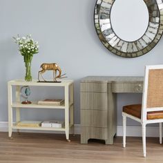 a white desk with a mirror on the wall above it and a chair next to it