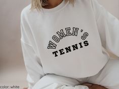 -Women's Tennis Crewneck Sweatshirt. Great gift for any sports fanatic.  -Crewneck sweatshirt, unisex sizing (refer to size chart).  -Comfortable, true to size sweatshirt. If you prefer a more fitted option, we recommend you size down.  -Comes in 3 neutral color options: white, sand, ash (as shown in photos). SHIRT DETAILS: -Ideal for any situation, a unisex heavy blend crewneck sweatshirt is pure comfort. These garments are made from polyester and cotton. This combination helps designs come out Sporty Oversized Sweatshirt For Sports Events, Sporty T-shirt With Lettering And Crew Neck, Sporty T-shirt With Lettering, Crew Neck, Relaxed Fit Lettering Sweatshirt For Sports, Relaxed Fit Sweatshirt With Lettering For Sports Events, Sporty Crew Neck Sweatshirt With Lettering, Crew Neck T-shirt With Team Spirit, Sporty Sweatshirt With Screen Print For Sports, Sporty Sweatshirt With Letter Print