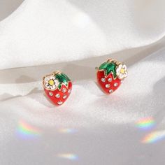 "Our Strawberry Earrings are seriously the cutest stud earrings you can find! Add a touch of cottagecore vibes with these cuties! Intricately detailed with teeny strawberry blossoms, teeny crystals, & sheer enamel! Fruity, sweet, & deliciously juicy - yes plz! Wildflower + Co. Jewelry. ♥ Measurements: dainty - approx. 3/8\" ♥ Materials: enamel, teeny crystals, & dipped in gold plating. Posts are titanium - good for sensitive ears! ♥ Packaged in our cute gift box ♥ Designed by & exclusive to Wild Whimsical Red Jewelry For Valentine's Day, Red Whimsical Jewelry For Gift, Whimsical Red Jewelry For Gift, Whimsical Red Jewelry For A Gift, Red Whimsical Nickel-free Earrings, Whimsical Red Drop Earrings, Cute Multicolor Earrings For Mother's Day, Whimsical Red Nickel-free Earrings, Playful Earrings For Valentine's Day Gift