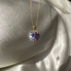 Add a touch of regal elegance to your jewelry collection with this Purple Royal Heart Necklace. The tiny violet halo pendant is made of non-tarnish 925 sterling silver, making it a durable and affordable choice for a love-themed gift. The purple color adds a touch of whimsy and femininity to any outfit, making it perfect for any occasion. Whether you're dressing up for a night out or just want to add a pop of color to your everyday look, this Purple Royal Heart Necklace is the perfect choice. Bu Elegant Round Gemstone Heart Necklace, Purple Heart Cut Sterling Silver Necklace, Purple Heart-cut Sterling Silver Necklace, Elegant Round Heart Necklace With Birthstone, Purple Heart Necklace For Anniversary, Purple Sterling Silver Heart Cut Necklace, Purple Heart Pendant Necklace For Anniversary, Purple Sterling Silver Heart Pendant Necklace, Sterling Silver Purple Heart Pendant Necklace