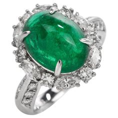 This exquisite GIA Genuine Emerald & Diamond Cocktail Ring is expertly crafted in solid platinum with a total weight of 9.54 grams. The emerald with a weight of approx. 5.17 carats are surrounded by (6) round cut and (6) marquise cut genuine natural diamonds,  (12) round-cut genuine natural diamonds placed on either side of the ring. All  G-H color, and VS clarity forming a dazzling oval halo, The top of this piece measures 17 mm x 22 mm, 10 mm (height) currently US ring size 4.75 and sizable. W Jewelry Appraisal, Luxury Timepieces, Diamond Cocktail Rings, Gems Jewelry, Natural Emerald, Emerald Diamond, Selling Jewelry, Buying Jewelry, Cocktail Rings