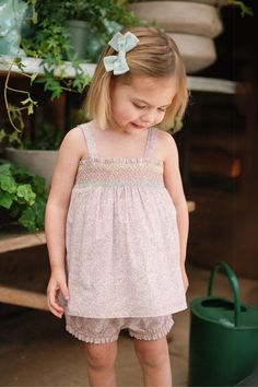 Our two-piece Rosie Baby Set in our new Scattered Blooms print is functionality garbed in sweet femininity. The swing style top features a darling, hand-smocked rainbow threaded across dainty petals of rosy pink daylilies and tiny daisies. On the bottom, our best-selling Lulu Bloomer frees up those squirmy legs to move Cute Pink Smocked Dress With Smocked Back, Pink Smocked Dress For Summer Playtime, Playful Floral Smocked Dress For Summer, Playful Smocked Floral Dress For Summer, Pink Smocked Dress For Playtime In Summer, Playful Smocked Dress For Spring With Smocked Bodice, Playful Smocked Dress With Smocked Bodice For Spring, Spring Playful Smocked Dress With Smocked Bodice, Playful Smocked Dress With Floral Print For Summer