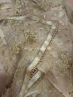 This is a Dupatta made on orders. It is made using golden color net fabric with gold sequine embroidery all over. We stitch a beautiful golden lace to all sides of it and decorate with tassels. Dupatta is having a length of 100 inches and width of around 40 inches. I don't keep it readymade I only make it exclusively for my customers. Can be fully customised. Traditional Sets With Mirror Work And Net Material, Semi-stitched Net Sharara With Mirror Work, Designer Sequin Dupatta For Diwali, Sequin Saree Choli For Diwali, Sequin Choli For Diwali, Designer Wear Chinon Salwar Kameez With Sequins, Reception Chinon Salwar Kameez With Sequins, Reception Sequin Chinon Salwar Kameez, Traditional Net Dupatta With Sequins