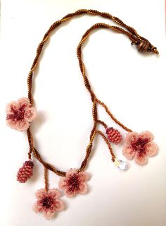 Thene of a kind asymmetrical beaded cherry blossom necklace, 100% designed and hand-crafted by me! This 40 cm unique, artisan jewelry is meant to look exactly like the magnificent spring cherry blossom branches so you can wear one on your neck and look like an ethereal nymph! It is entirely made with premium quality miyuki glass beads that they are known to made exclusively in Japan and are considered one of the most refined, luxurious tiny beads in the world! You will not wear a simple necklace. This is a piece of art made with thought, care, love, and the highest quality materials. In the personalization section, you can type the length you prefer as well as your own adjustments regarding the style of the necklace. Handmade Pink Choker As Gift, Handmade Pink Choker As A Gift, Handmade Delicate Beaded Necklaces With Round Beads, Handmade Delicate Beaded Necklace With Round Beads, Delicate Handmade Beaded Necklaces With Round Beads, Pink Beaded Necklace With Flower Pendant, Handmade Delicate Flower Necklace, Handmade Delicate Choker With Round Beads, Handmade Delicate Choker For Gifts