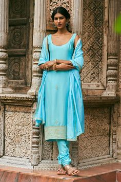 Aqua blue straight kurta with placement hand embroidered buttis. Paired with a churidar and matching hand embroidered dupatta.
Components: 3
Pattern: Hand Embroidery
Type Of Work: Floral
Neckline: Round Neck
Sleeve Type: Sleeveless
Fabric: Dupion Silk, Pure Silk
Color: Blue
Other Details: 
 Model height: 5ft 9inches, wearing size XS
Length:
Kurta: 42 inches
Churidar: 40 inches
Occasion: Sangeet - Aza Fashions Blue Georgette Sets With Embroidered Border, Blue Churidar With Sheer Dupatta, Fitted Blue Churidar With Sheer Dupatta, Fitted Blue Anarkali Set With Embroidered Border, Designer Blue Dresses With Embroidered Border, Blue Anarkali Unstitched Suit With Embroidered Border, Blue Sleeveless Kurta For Festive Occasions, Festive Sleeveless Blue Kurta, Festive Blue Sleeveless Kurta