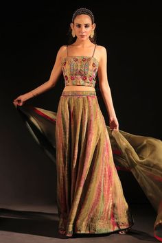 Olive green tie-dye pattern flared lehenga. Paired with a floral embroidered blouse with dori string details and shaded organza dupatta. - Aza Fashions Summer Reception Green Lehenga, Green Silk Bohemian Sharara, Bohemian Green Choli With Sheer Dupatta, Green Bohemian Silk Sharara, Bohemian Green Silk Sharara, Green Bohemian Summer Choli, Summer Silk Lehenga With Dupatta, Bohemian Green Lehenga With Sheer Dupatta, Bohemian Green Sharara For Reception