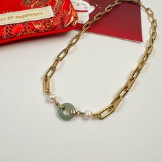 Combining the richness of pearls, the energy of jade, and the luxury of 14k gold plating over handcrafted stainless steel—our Beauty & Affluence Necklace is the perfect embodiment of sophistication. With white freshwater pearls on either side of an authentic 12mm round Burmese jade, this necklace isn't about aesthetics. It holds significant symbolism. Pearls are linked to purity, wisdom and abundance, while jade represents resilience and safeguarding. Details 14k gold plated on handcrafted stain Elegant Jade Necklace With Adjustable Chain, Gold-plated Pearl Necklace With Gold Chain For Gift, Elegant Jade Pearl Necklace For Gift, Burmese Jade, Jade Crystal, Demi Fine Jewelry, White Freshwater Pearl, White Gold Jewelry, Jade Stone